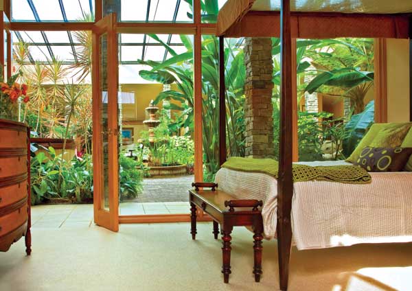The bedroom opens onto the home's central atrium, offering stunning views.